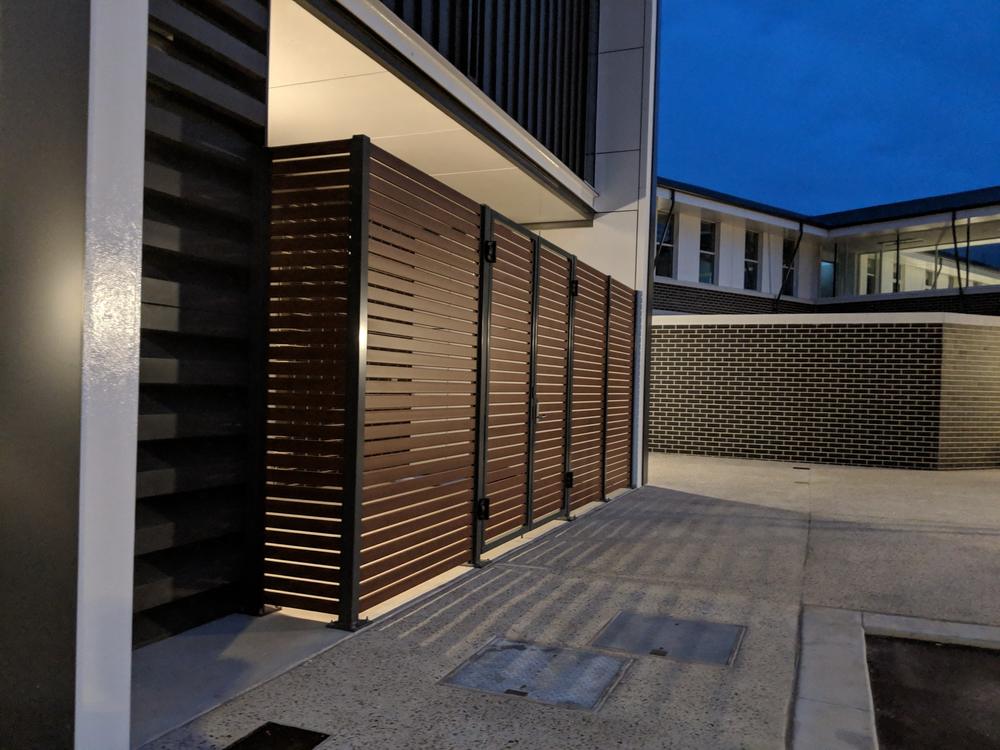 Horizontal aluminium slat screening beside a building