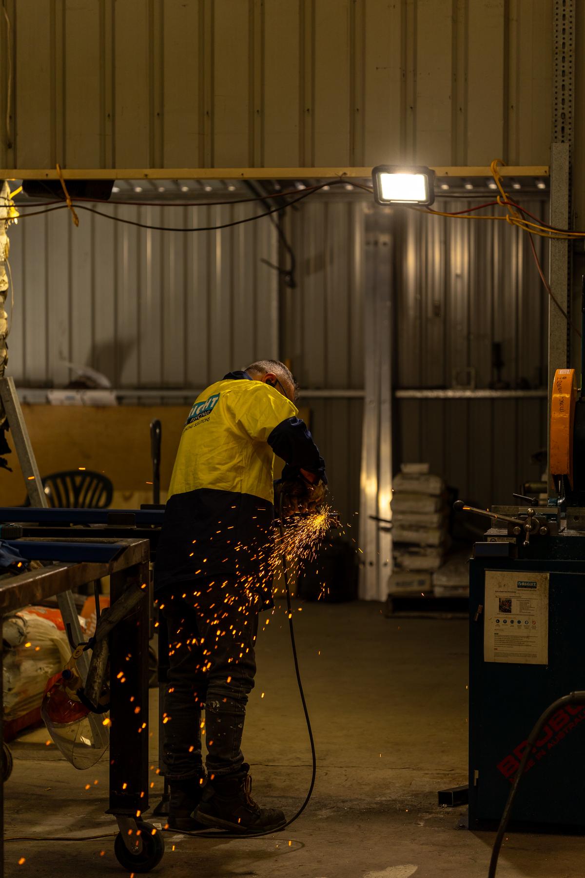 RMF fabricator grinding steel in the Maddington workshop
