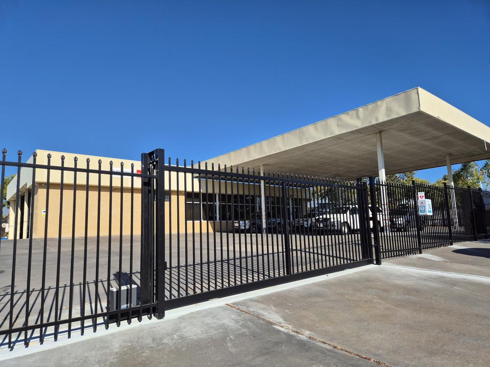 Black Garrison sliding gate across a car park entry