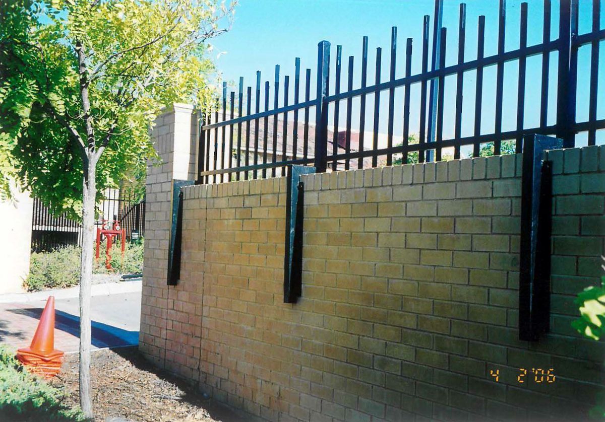 Early security fencing on a brick wall, Feb 2006