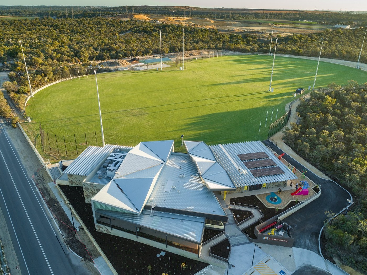 Aerial view of the Frankland Park sports precinct, with chainmesh fencing around the oval