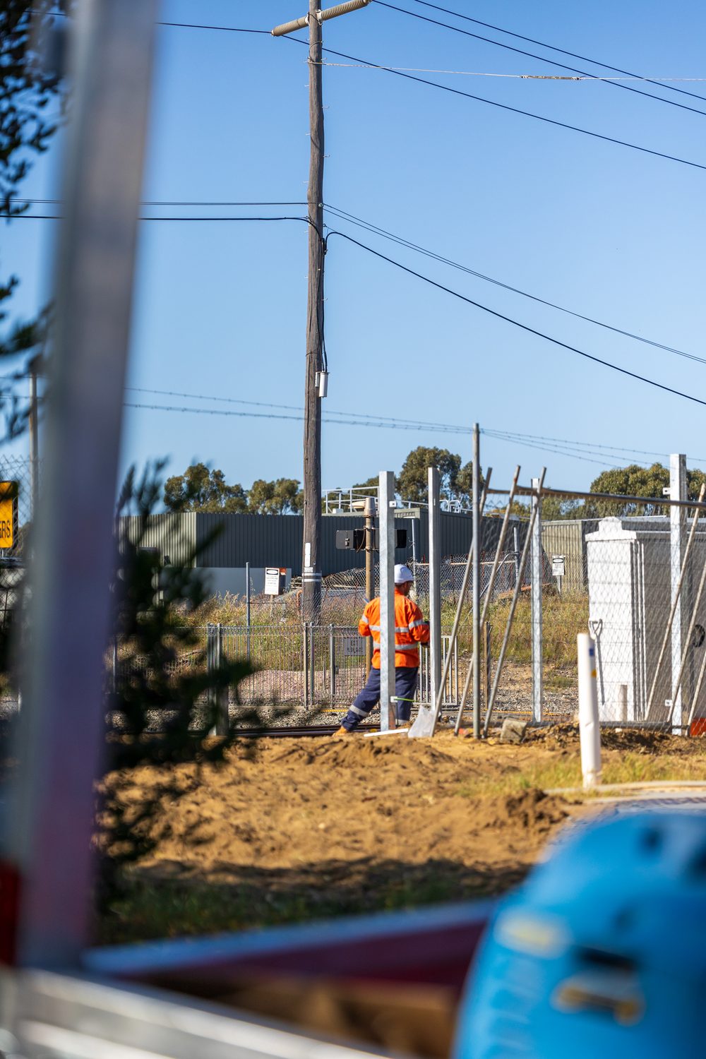 RMF technician installing fencing alongside the rail corridor at TCL West