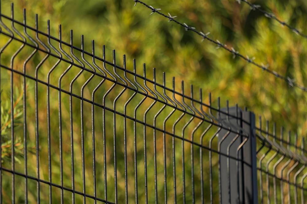 Black welded mesh security fence panels with barbed wire
