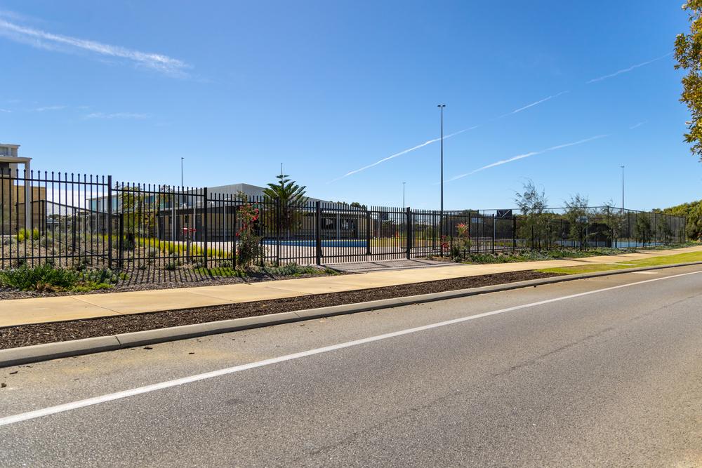 Black Garrison double swing gates in a security fence line