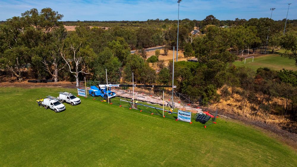 RMF crew installing a back net at a council oval